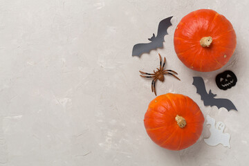 Halloween decoration and pumpkins on concrete background, top view