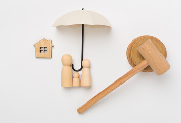 Wooden family figures with judge's gavel on color background,top view