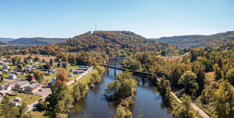 Aerial panorama of the small town of Confluence in Somerset County in Pennsylvania with fall colors on the leaves and trees - obrazy, fototapety, plakaty