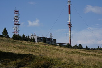 The Krížava transmitter is a radio and television transmitter on the hill Mala Fatra in Slovakia. Next is a free-standing steel telecommunications tower as well as a large service building. - obrazy, fototapety, plakaty