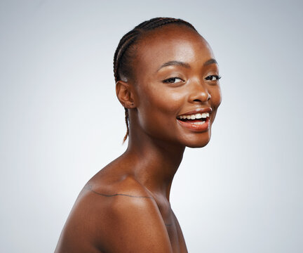 Smile, glow and portrait of a black woman for skincare, dermatology and wellness on a studio background. Happy, face and an African girl or female model for cosmetics, skin health and beauty