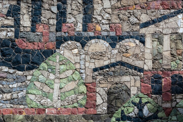 Fragment of a wall made of stones of different colors for use as an abstract background and texture.