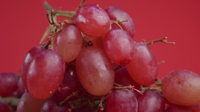 Red fruits fresh organic grapes on red background