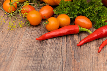 Hot peppers,pumpkin, tomatoes and parsley on the table.Autumn vegetables.Cooking