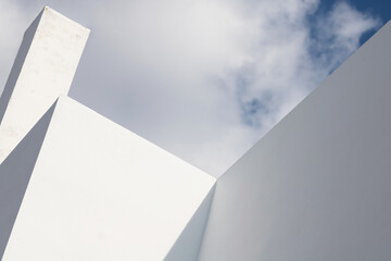 Abstract architecture. Close up of a white facade with overcast sky - Powered by Adobe