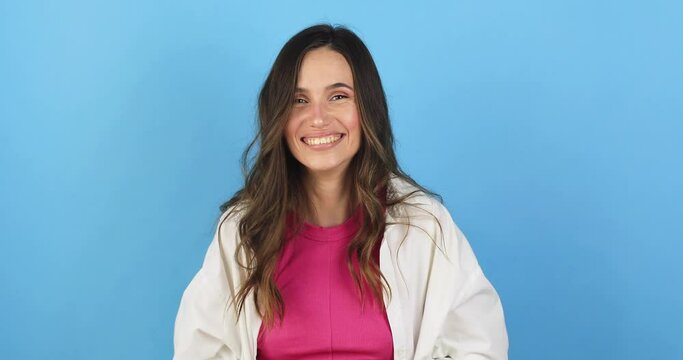 Amazed excited woman hairstyle in white shirt, pink top open mouth in surprise looking at camera with big eyes, shocked isolated on blue background. Oh my god wow, yes gesture, win dance.