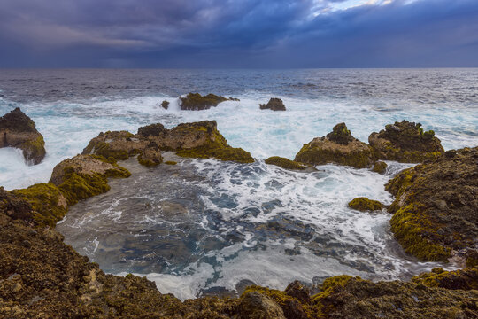 Atlantic Ocean and lava rock coast at dawn at Charco del Viento in La Guancha on Tenerife in the Canary Islands, Spain