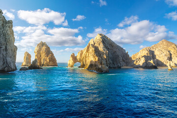 Sunlight highlights the famous El Arco Arch at the Land's End granite rock formations on the Baja...
