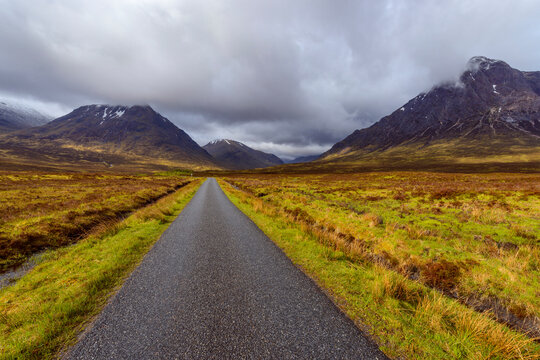 Road with mountains in the highlands at Glen Coe in Scotland, United Kingdom