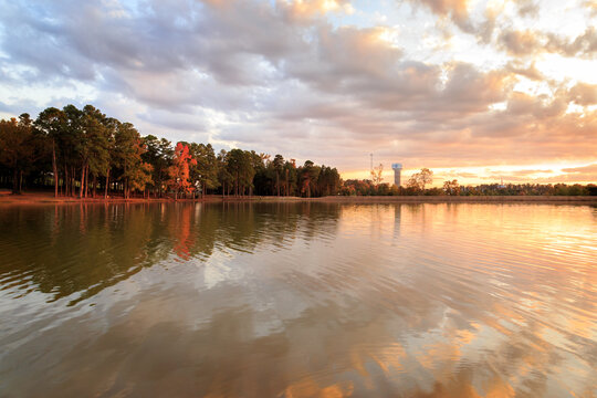 Autumn Sunset At The Longview Water Tower with a lake and sunset clouds