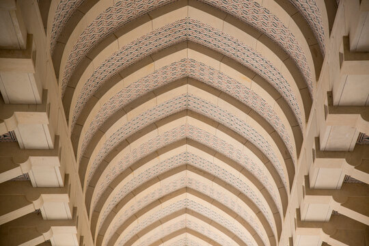 Low angle view of the patterned arched ceiling inside the Sultan Qaboos Grand Mosque; Muscat, Oman