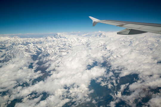 Mount Everest viewed from the window of a jet in the Himalayas; Nepal