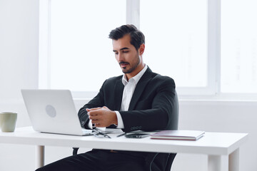 Fototapeta premium Man desk laptop office worker computer working suit businessman sitting tired business