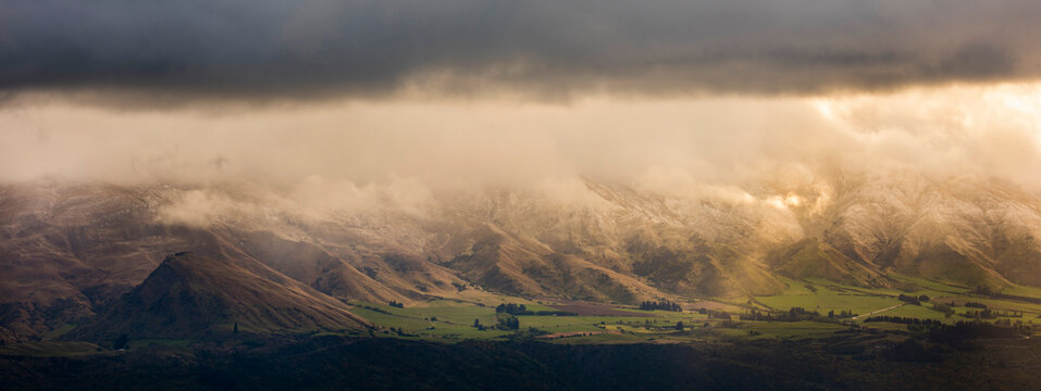 Sunrise light shines on the Cardona river valley in the Otago region of New Zealand; New Zealand