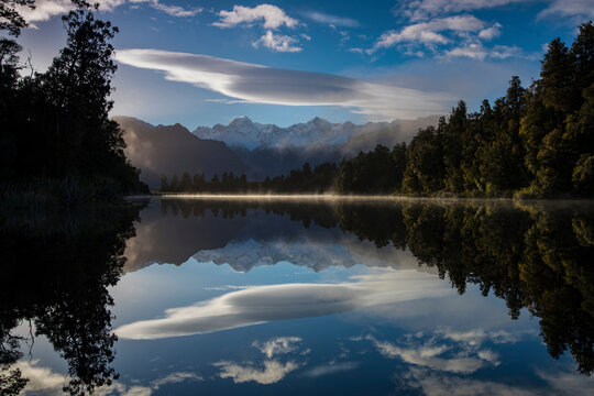 Lake Matheson at sunrise with Mount Cook on right center and Mount Tasman on left center; South Island, New Zealand