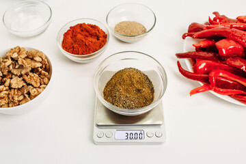 Weighing portions of ingredients to prepare a dish.