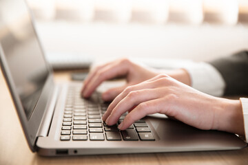 Woman typing on laptop