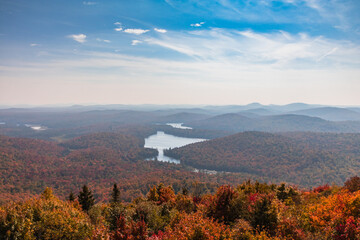 Adirondacks mountain range view from Mt Arab fire tower with brilliant fall foliage on a sunny afternoon 
