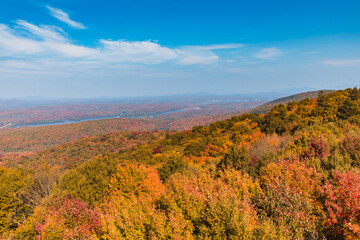 Adirondacks mountain range view from Mt Arab fire tower with brilliant fall foliage on a sunny afternoon 