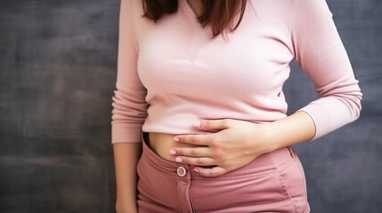 Young woman having painful stomachache. Chronic gastritis. Abdomen bloating concept.