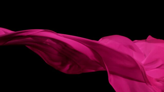 Super Slow Motion of Waving Transparent Colored Cloth. Filmed on High Speed Cinema Camera Phantom VEO 4K, 1000 fps. Isolated on Black Background.