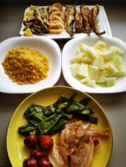 Typical Spanish food, migas, garnished with peppers, melon, fried fish, chorizos and bacon