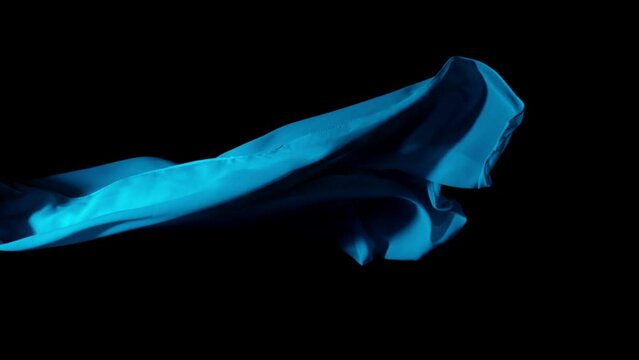 Super Slow Motion of Waving Transparent Blue Cloth. Filmed on High Speed Cinema Camera Phantom VEO 4K, 1000 fps. Isolated on Black Background.