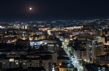 Obraz premium Night Jerusalem aerial view. Jaffa street, moon