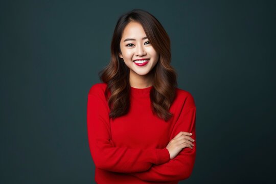 Portrait of young Asian woman with positive expression, arms crossed, smiling broadly, wearing Christmas clothes and Christmas look, generative ai
