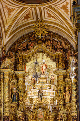 Fototapeta na wymiar Old altar of a historic baroque church completely covered in gold in Ouro Preto, Minas Gerais