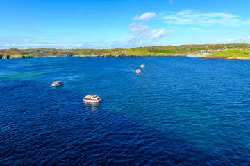 Multiple tender boats shuttle passengers at the cruise port harbor at Stornoway, Scotland, UK, on...