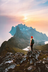 Traveler woman hiking outdoor in Norway travel adventure vacations healthy lifestyle girl hiker with backpack enjoying sunset mountains view © EVERST