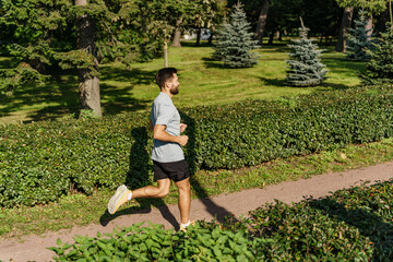 Runner exercises jogging for cardio endurance in sportswear in the park.   An active and healthy...