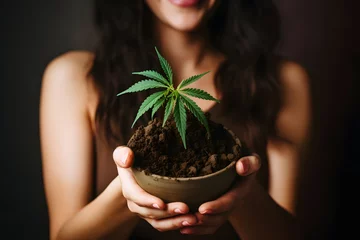 Foto op Plexiglas Frau mit einer Hanfpflanze in den Händen © Seegraphie
