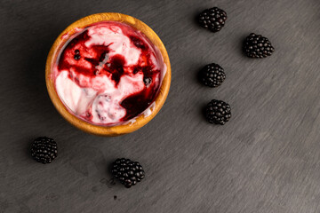 fresh yogurt with crushed juicy blackberries, preparation of yogurt