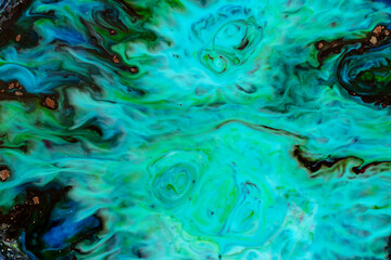 Closeup abstract color mixing of acrylic for use as background. Acrylic texture with marble pattern, green marbling background 