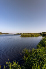 a wide river in sunny weather in early autumn