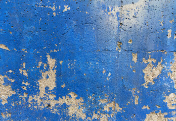 old blue wall texture with peeling paint