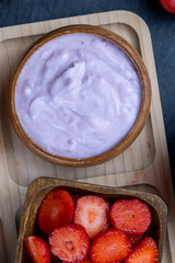 fresh yogurt made from milk with pieces of strawberries