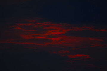 red sunset sky. sunset in the sky. sky with clouds. sunset between clouds. black and red sky.