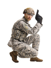 Young male soldier with gun crouching on white background