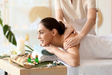 Obraz na płótnie Canvas Young woman getting massage in spa salon, closeup