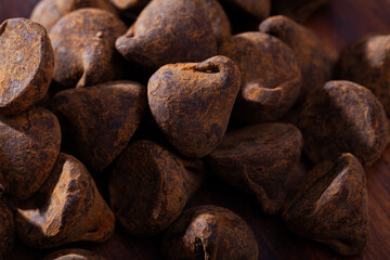 Close up view of delicious chocolate candies truffles in cocoa powder