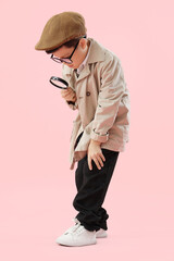 Cute little detective with magnifier on pink background