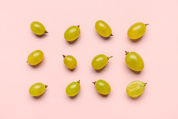 Fresh green grapes on pink background