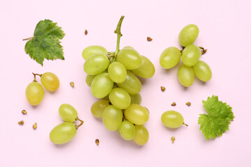 Fresh green grapes with leaves and seeds on lilac background