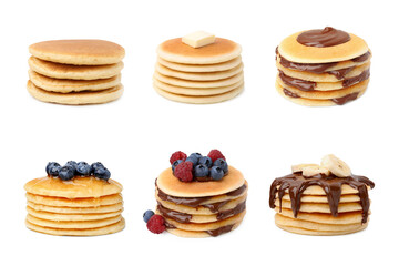 Set of tasty pancakes with toppings isolated on white