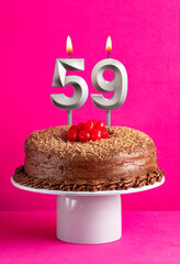 Birthday card with candle number 59 - Chocolate cake on pink background