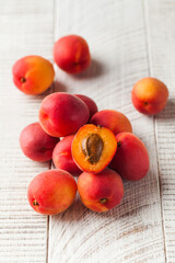 Ripe juicy sweet plums on a light wooden background. Fruit and harvest