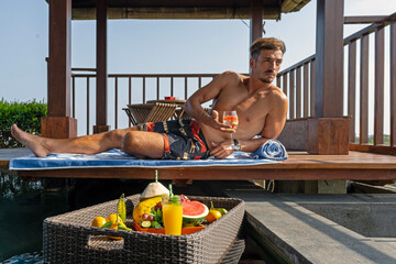 man having breakfast in the pool